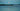 Full moon rising over calm water at night, casting soft moonlight across a peaceful landscape